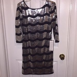 Low back, quarter sleeves, sparkly, mini dress.